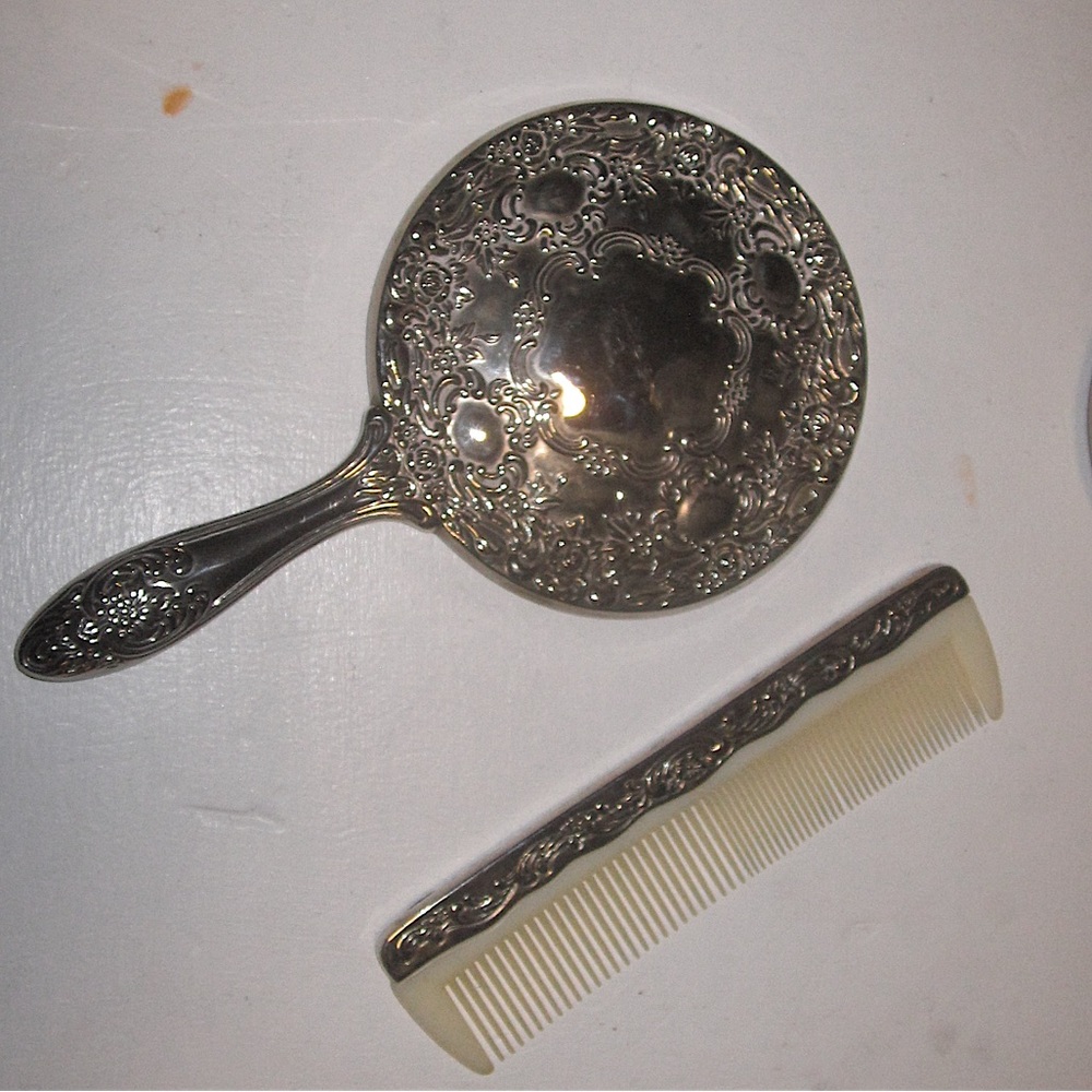 Vintage silver hand held mirror and matching comb